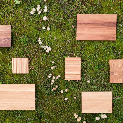 Sustainable wooden cutting boards on green moss, eco-friendly & stylish for any kitchen